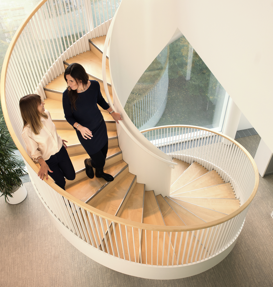 Colleagues walking on a modern spiral staircase