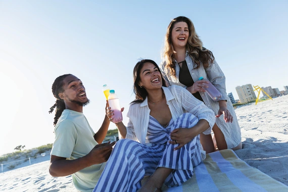 Group on the beach enjoying drinks and relaxing